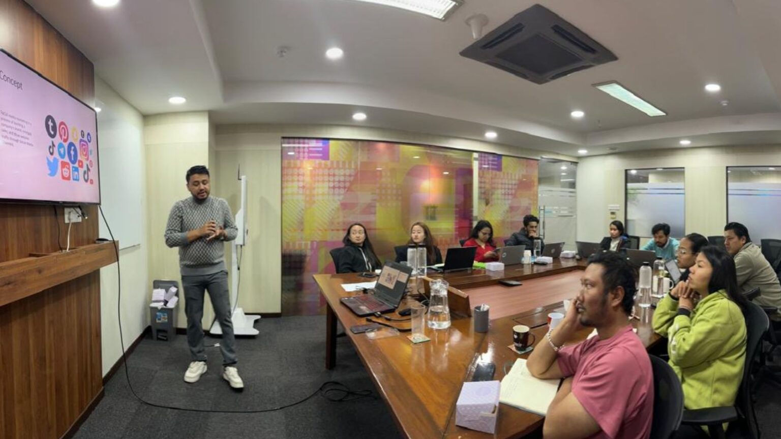 Instructor leading a data science workshop for learners at a conference table.